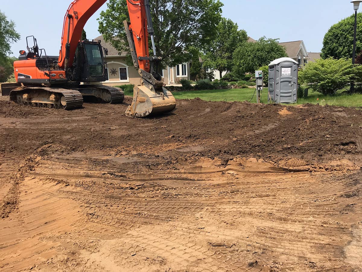 excavator smoothing out an a residential area