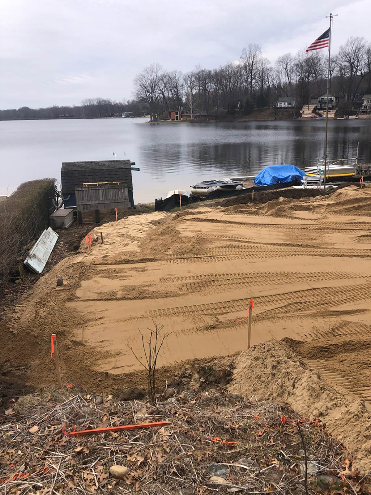 fresh sand leveled in front of lake