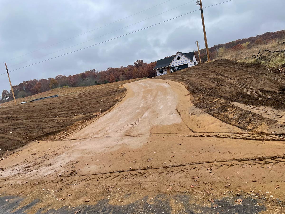 new driveway and topsoil graded for new home