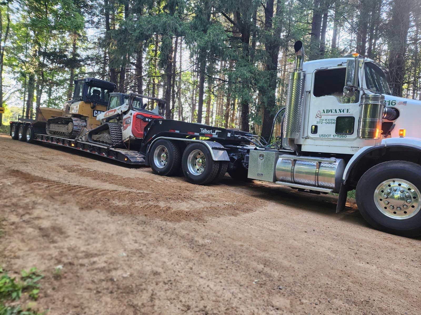 truck with trailer and bulldozers