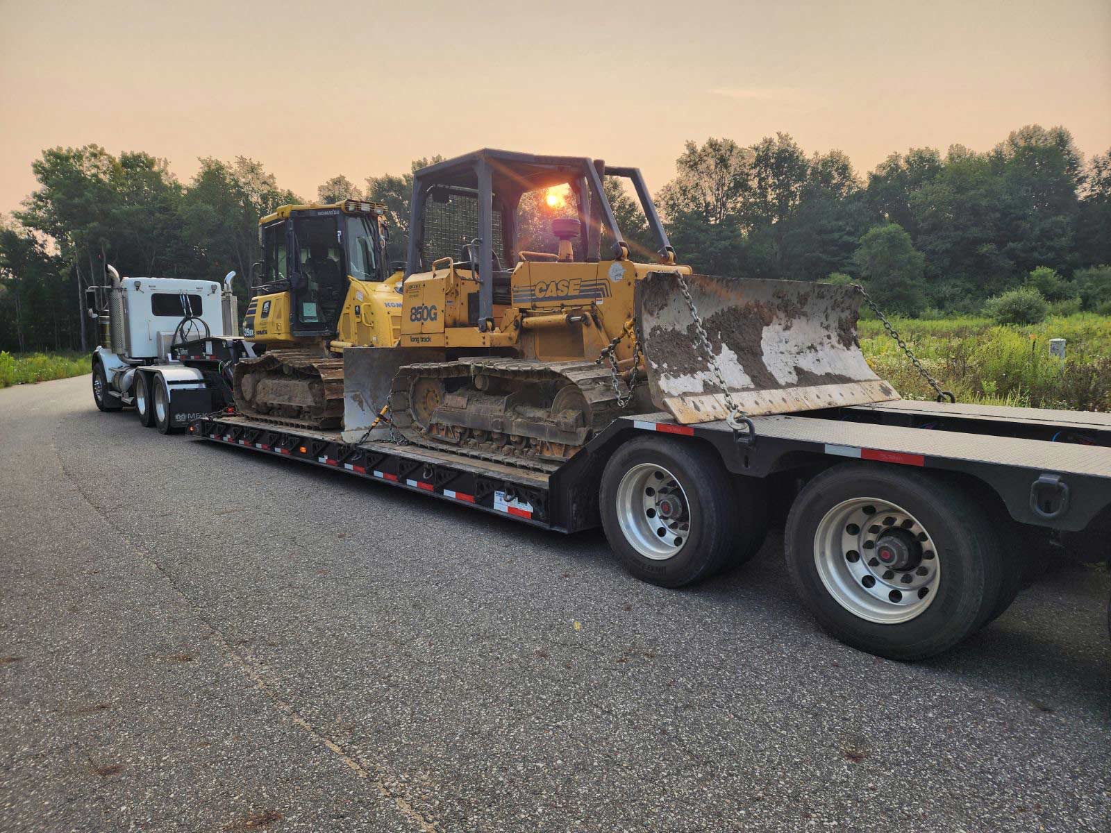 truck with trailer and two bulldozers