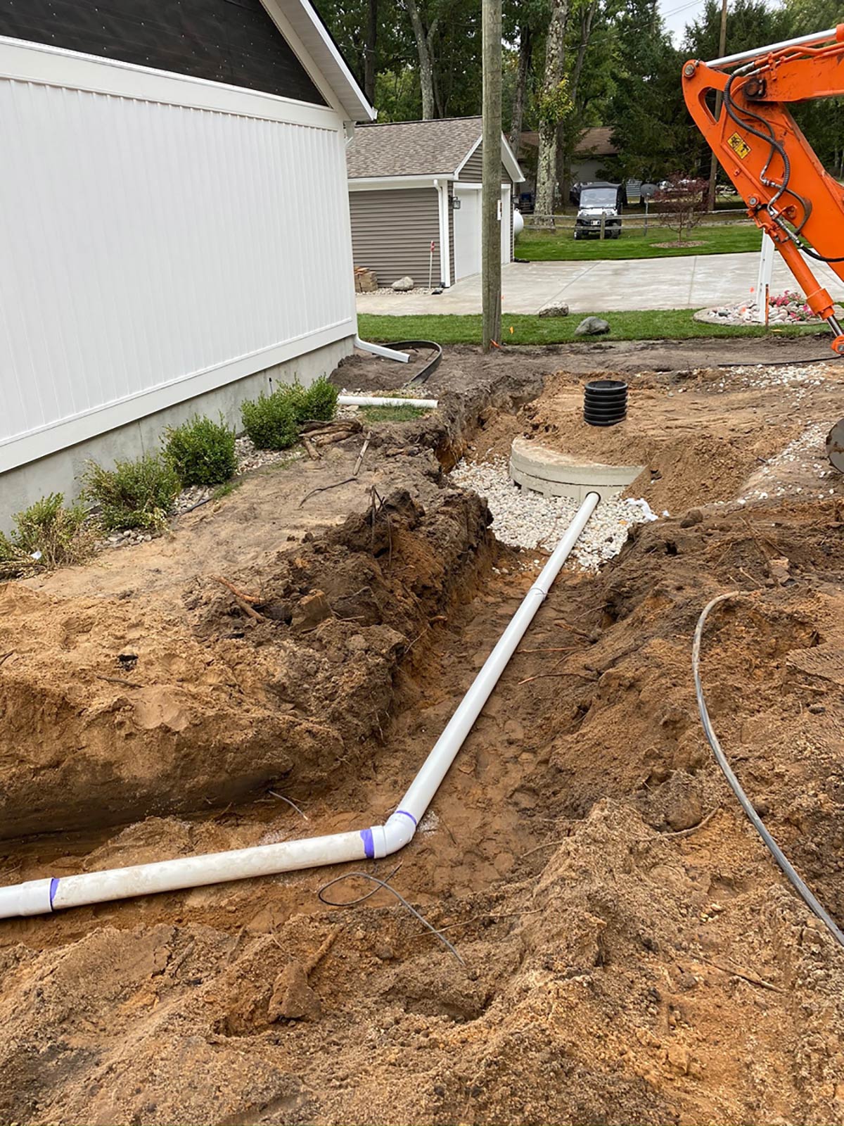 pipe in trench going to cement container for water management system